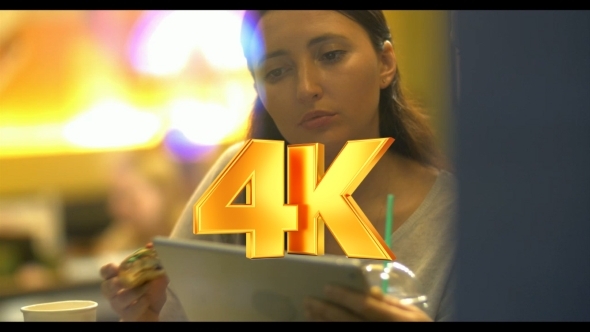 Women Friends Using Tablet PC And Eating Cake In Women Friends Using Tablet PC And Eating Cake In
