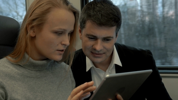 Friends Passing Time In Train With Tablet PC Friends Passing Time In Train With Tablet PC