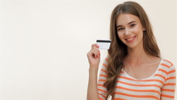 Attractive Girl Showing Thumbs-up With Credit Card Attractive Girl Showing Thumbs-up With Credit Card