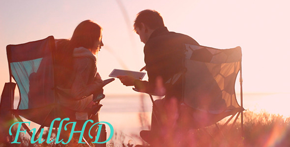 Couple Using Tablet At Dawn Couple Using Tablet At Dawn