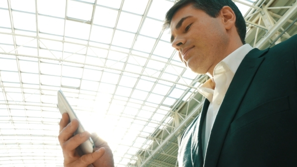 Businessman With Smartphone In Modern Building Businessman With Smartphone In Modern Building