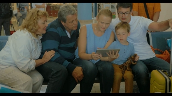 Family With Pad In The Waiting-room Of Airport Family With Pad In The Waiting-room Of Airport