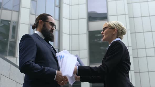 Nervous Businesswoman Throwing Papers in Front of Male Colleague, Stressful Job