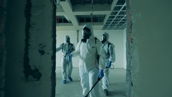 Disinfection Workers Are Inspecting Unfurnished Rooms alt