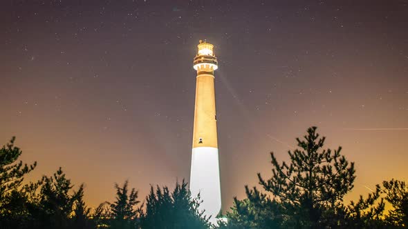 Timelapse of stars moving across the night sky behind the historic Barnegat Lighthouse. alt