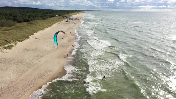 AERIAL: Surfer Riding Waves Very Close to Baltic Sea Shore