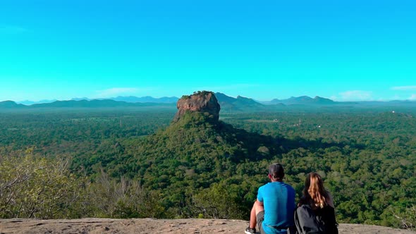 The couple looking in to Sigiriya rock beautiful views at Pidurangala mountain.