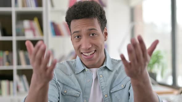 Welcoming Young African American Man Pointing at the Camera Inviting alt