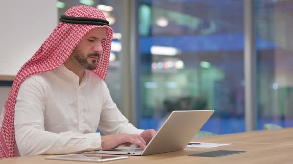 Sick Arab Businessman with Laptop Coughing alt