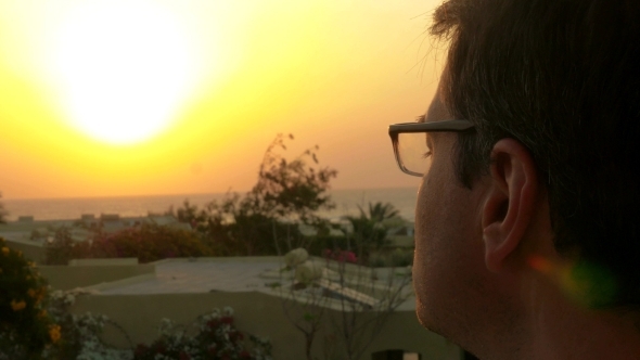 Man Putting On Glasses And Enjoying Nature Scene Man Putting On Glasses And Enjoying Nature Scene