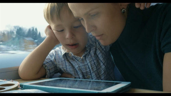 Boy And His Mother Watching Cartooins In Tablet Boy And His Mother Watching Cartooins In Tablet