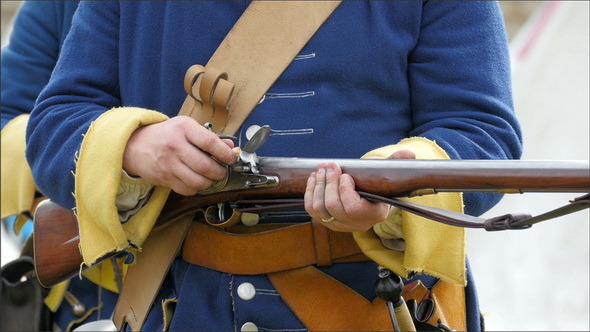 A Guard Putting Some Bullets on his Gun