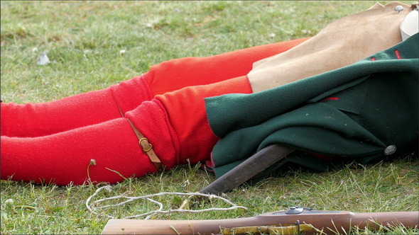 One Guard in Red Socks is Lying on the Grass