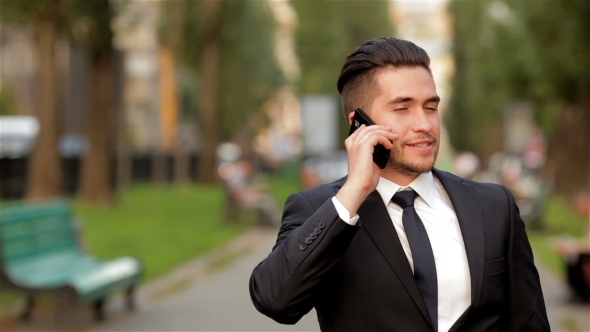 Young Businessman Talking On Mobile Phone Young Businessman Talking On Mobile Phone
