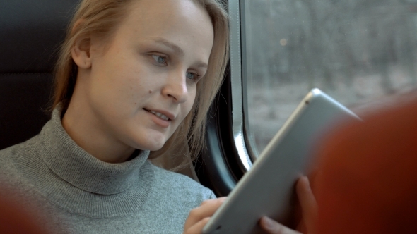 Smiling Woman With Tablet In Train Smiling Woman With Tablet In Train