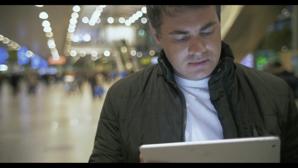 Young Man Working With Touch Pad At The Airport Young Man Working With Touch Pad At The Airport
