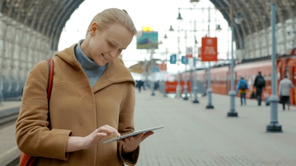 Woman With Tablet On The Railway Station Woman With Tablet On The Railway Station