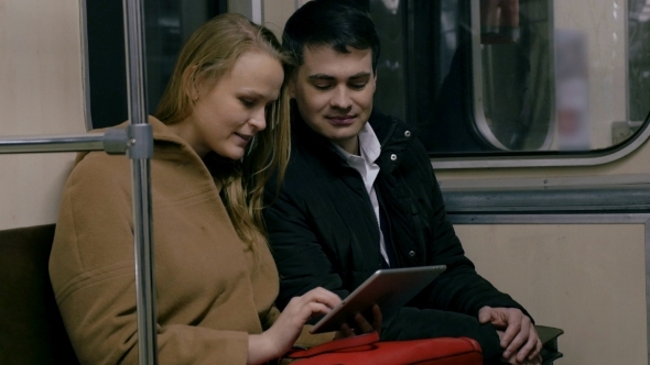 Couple With Tablet PC In Public Transport Couple With Tablet PC In Public Transport