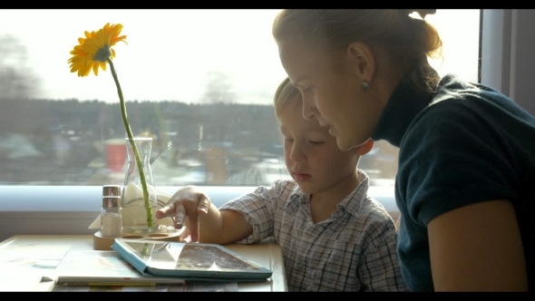 They Passing Time With Touch Pad In The Journey They Passing Time With Touch Pad In The Journey