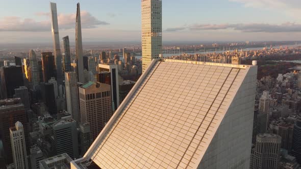 Ascending Tilt Down View of Oblique Roof of Business Skyscraper in City at Dusk alt