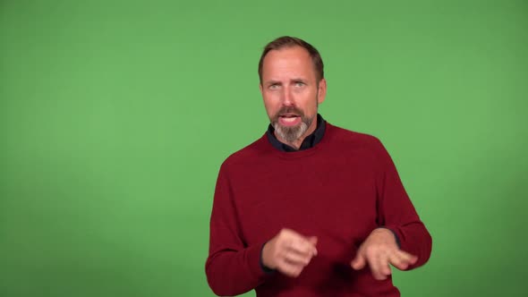 A Middleaged Handsome Caucasian Man Dances and Looks at the Camera  Green Screen Background