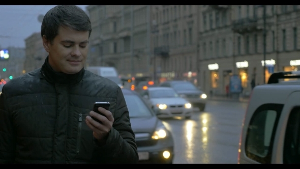 Man With Cellphone In The Evening Rainy City Man With Cellphone In The Evening Rainy City