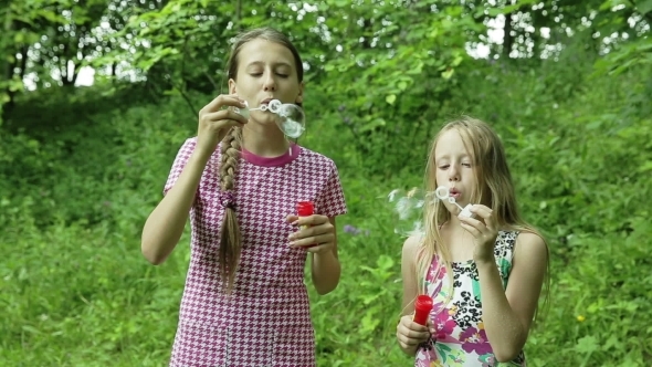 Young Girls Blowing Soap Bubbles Outdoor Young Girls Blowing Soap Bubbles Outdoor