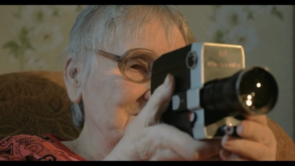 Elderly Woman With Retro Camera At Home Elderly Woman With Retro Camera At Home
