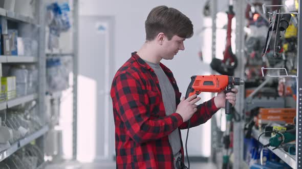 Man Choosing Drill in Hardware Store alt