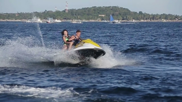 Happy Couple Riding Jet Ski Happy Couple Riding Jet Ski