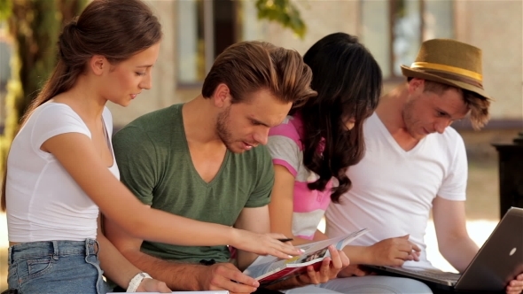 Group Of Students Studying Outdoors Group Of Students Studying Outdoors