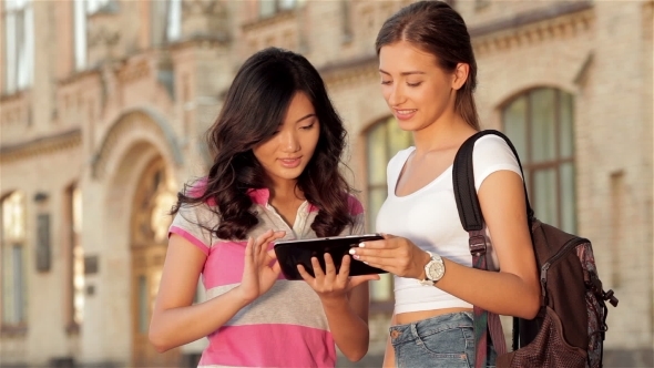 Two Cute Girls Web Surfing On a Tablet Two Cute Girls Web Surfing On a Tablet