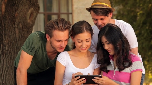 Girl Showing Her Friends Some Video On a Tablet