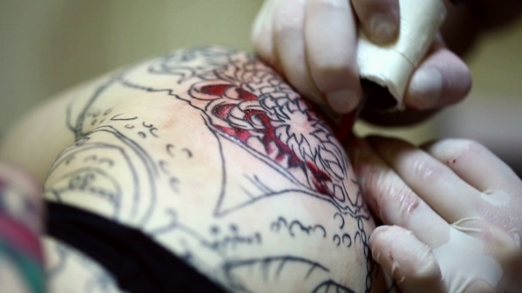 Tattooist Draws Tattoo In Red Ink