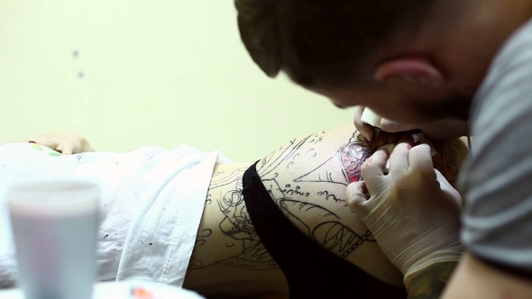 Creative Master Draws Tattoo On Woman's Hip