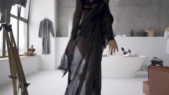 Cute Young Blond Woman in Beautiful Clothes in the Bathroom. The Girl Preparing for the Date. Happy alt