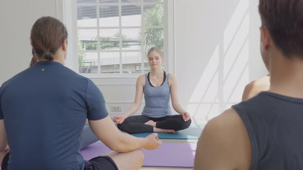 Group of diversity people doing meditation in yoga class