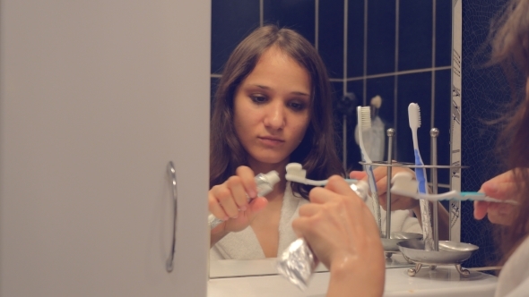 Young Pretty Woman Washing Face And Brushing Teeth