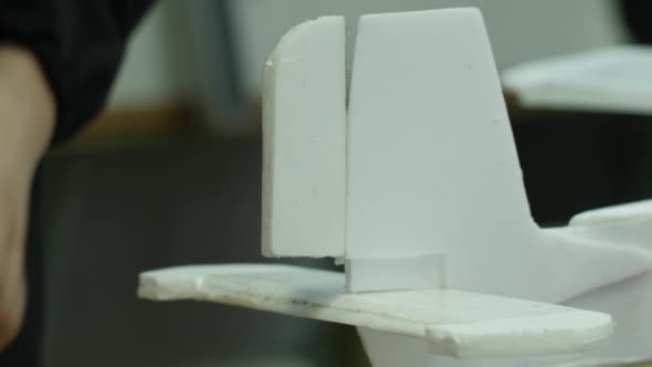 Child's Hands Are Measuring The Model of Plane Child's Hands Are Measuring The Model of Plane