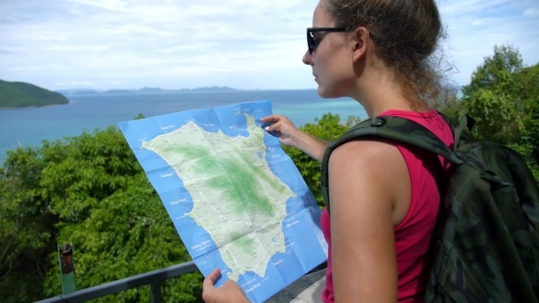Female Tourist With Backpack On Mountain Reading Female Tourist With Backpack On Mountain Reading
