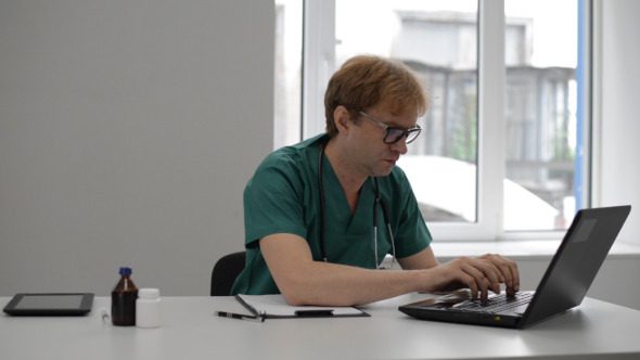 Doctor Typing on Laptop