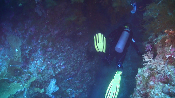 Divers Swimming Through Underwater Cave Divers Swimming Through Underwater Cave