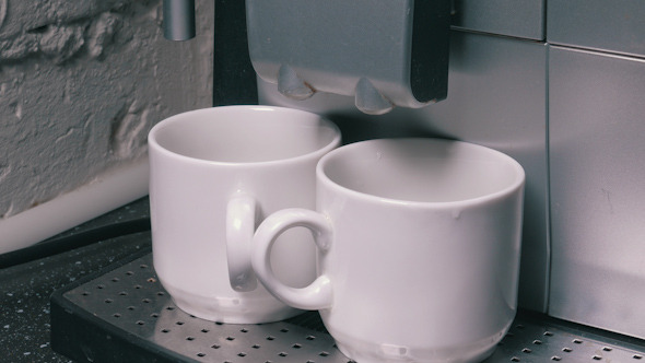 Coffee Machine Making Espresso into a Two Cap Coffee Machine Making Espresso into a Two Cap