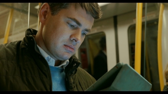 Man Using Tablet PC In Metro Train Man Using Tablet PC In Metro Train