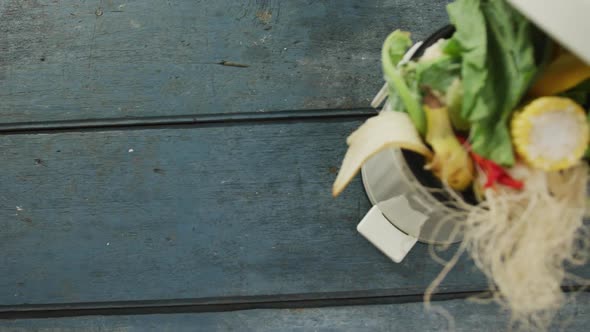 Video of white compost bin with organic waste and copy space on grey wooden background alt
