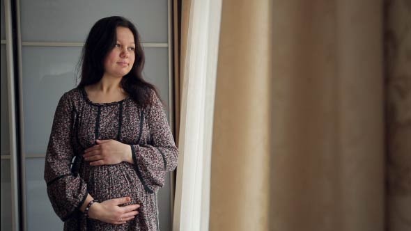 Pregnant Woman Stroking Her Abdomen Pregnant Woman Stroking Her Abdomen