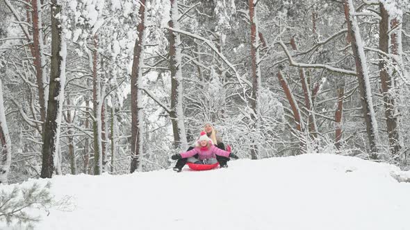 Happy mom plays with her daughter in a winter park