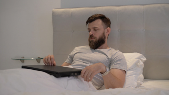Freelancer Finishes Using Laptop in Bedroom alt