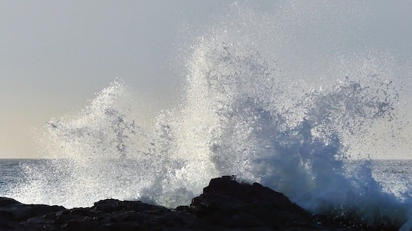 Waves Break On The Rocks 2