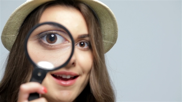 Beautiful Girl With Loupe Zooming Her Eye Beautiful Girl With Loupe Zooming Her Eye